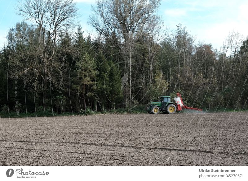 Farmer spreads fertilizer on autumn field with his tractor peasant Agriculture Field Tractor Environment Meadow Machinery Earth Forest Autumnal Rural