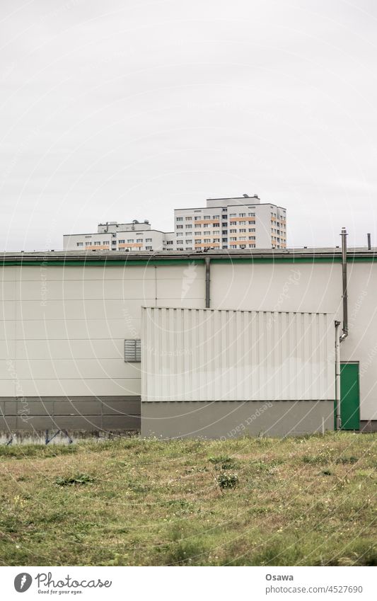 High-rise building behind fallow land / barrack Apartment Building Prefab construction FALLOW LAND Facade Architecture November Window Town Manmade structures