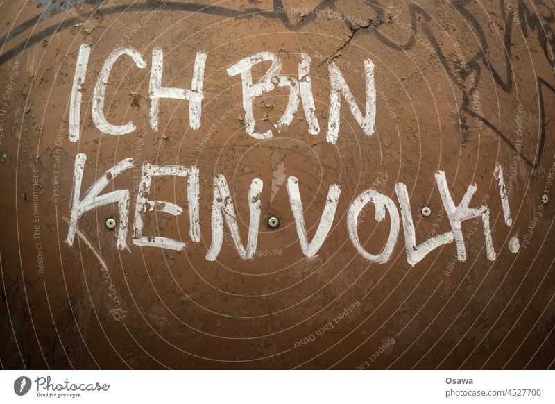 I AM NOT A PEOPLE! Subculture Subdued colour Gray Handwritten Authentic Remark Deserted Exterior shot Wall (building) Wall (barrier) Graffiti Facade Word