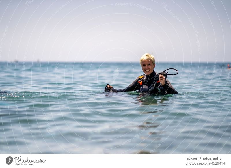 Happy woman getting ready to scuba diving in the Mediterranean Sea scuba dive open water sea andalusia enjoy sign ok happy fins adventure goggles mediterranean