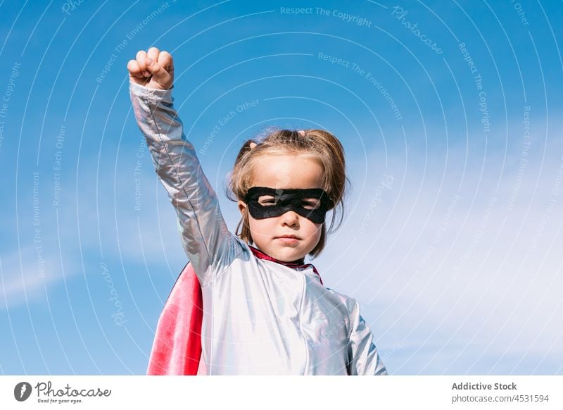 Brave kid in superhero costume showing fists girl child strong power courage pretend fearless gesture hill cape brave childhood strength protect cloak little