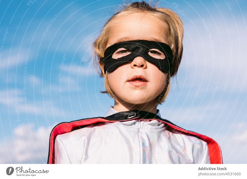 Girl in eye mask and superhero costume girl kid portrait carnival childhood fantasy brave pretend human face innocent imagination cape individuality cute power