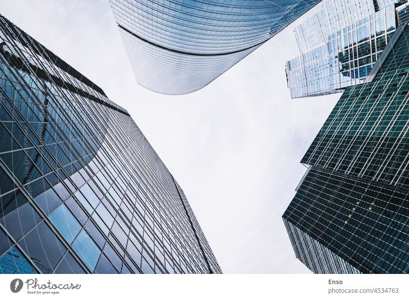 Bottom up view of skyscrapers, business district glass towers frame buildings overhead bottom up border high moscow city blue office corporate contemporary