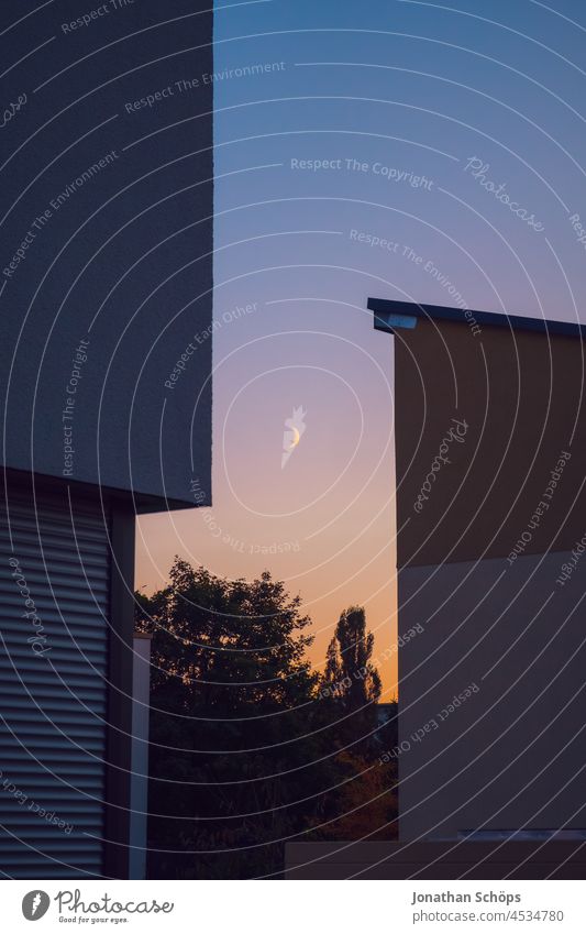 Increasing crescent moon in the evening sky behind modern houses increasing crescent Moon Waxing crescent moon Half moon Moonlight House (Residential Structure)