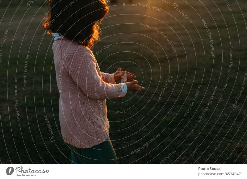 Cute girl looking at the hands Child childhood Girl 3 - 8 years Caucasian Happiness Leisure and hobbies Human being Infancy Colour photo Playing Exterior shot