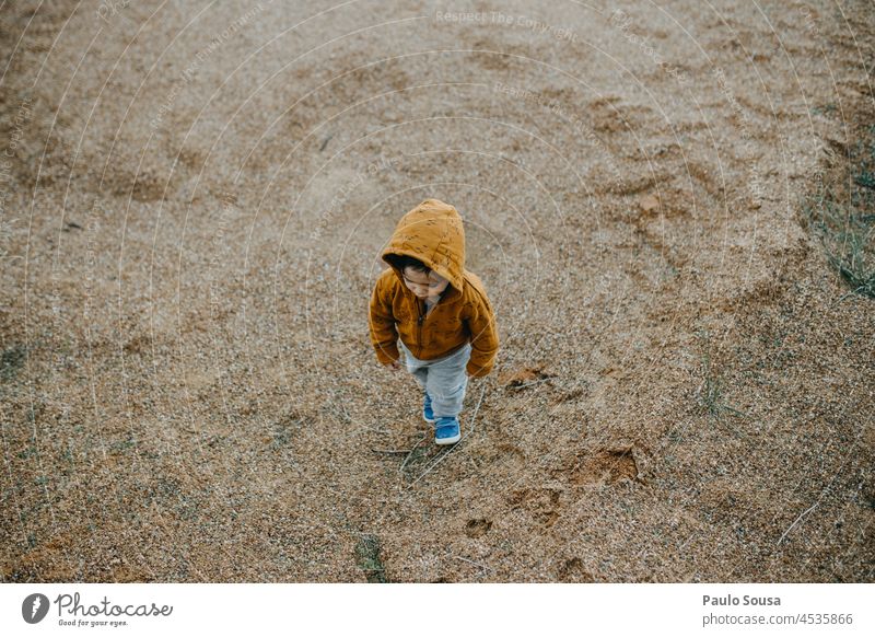 Child walking with orange hoodie childhood Caucasian 1 - 3 years Authentic Autumn Orange Hooded (clothing) Hooded sweater Nature Sweater Exterior shot