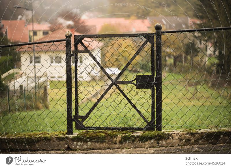 Old door to the garden Garden Meadow Exterior shot Colour photo Day Deserted House (Residential Structure) Metal Iron Rust selective focus Close-up Closed