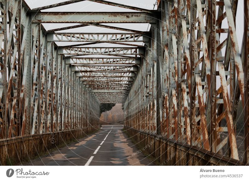 Old rusty iron bridge over the Peña reservoir, in the Jacetania region, Huesca province, Aragon, Spain old crossing over water autumn morning outdoors day