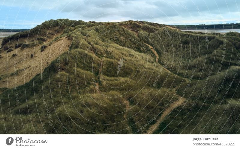 aerial drone view of the dunes of Tramore, Waterford Ireland. Sandhills natural park tramore water grassland aereal view desert republic of ireland seascape