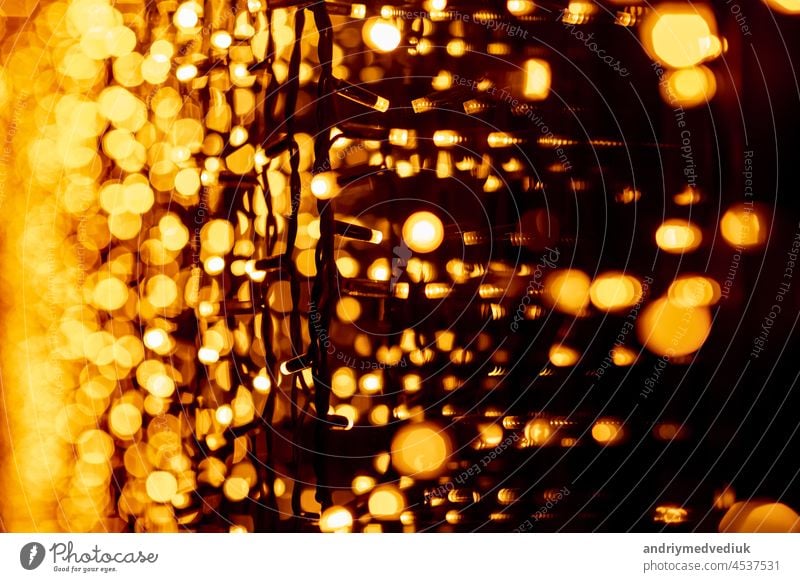 Abstract circular bokeh background of Christmaslight. bokeh from garlands. background for screensaver. Defocused lights. Blurred bokeh with yellow color lights.