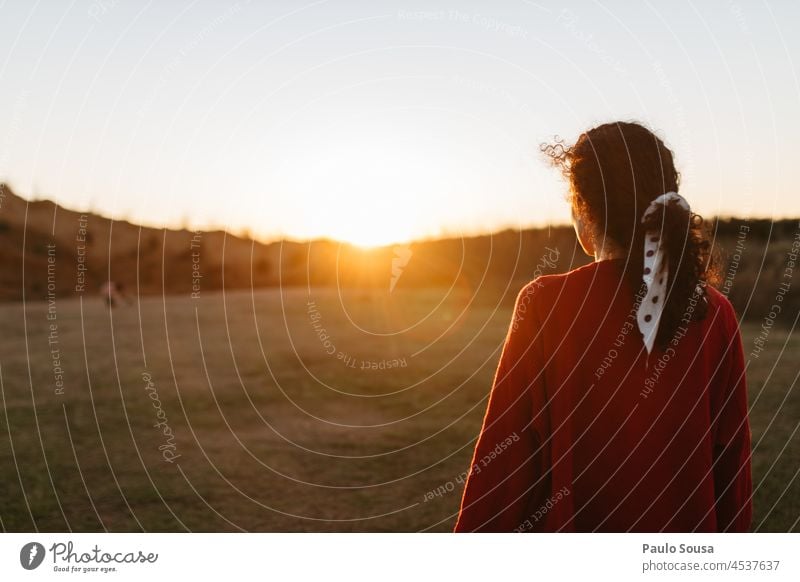 Woman looking at sunset Curly Authentic Feminine Happy Caucasian people Human being Lifestyle Adults curly hair young woman one person Sunset Autumn