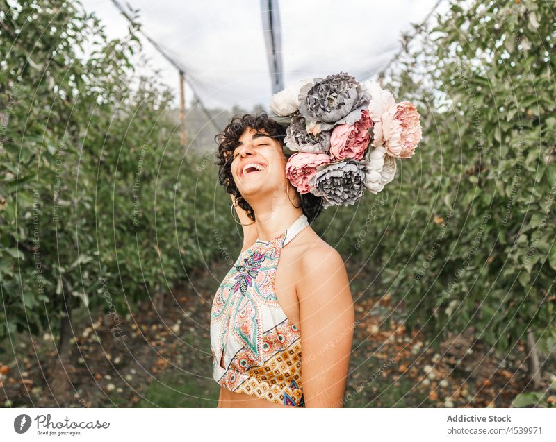 Laughing woman with bouquet of flowers laugh peony bloom garden female show blossom positive tree plant countryside fresh apple happy glad cultivate farmland