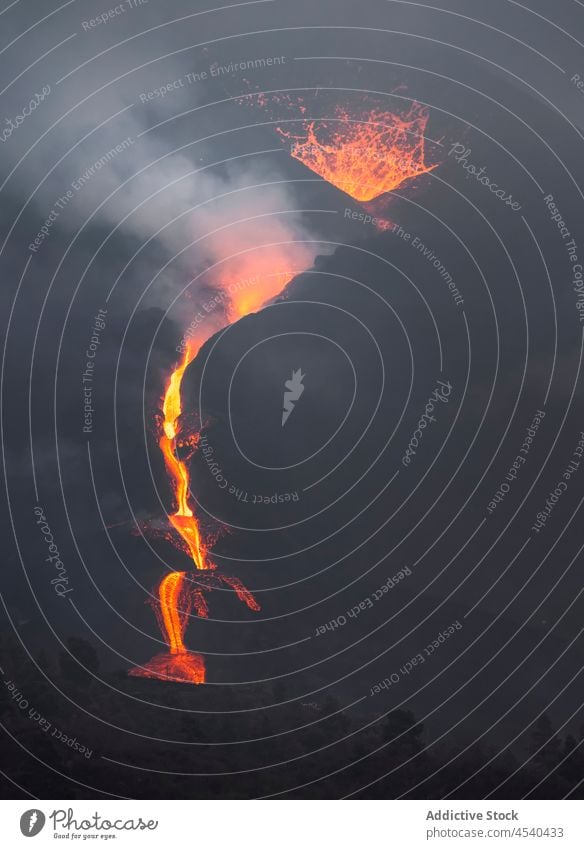 Bright orange lava emitting out of volcano at night erupt disaster nature mountain crater danger power devastate island motion cumbre vieja la palma