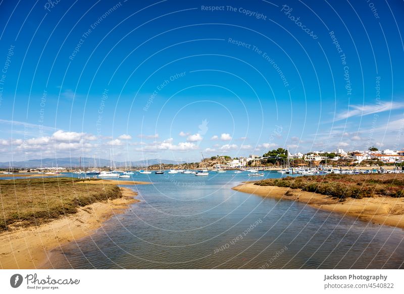 Coastal landscape with boats in Alvor, Algarve, Portugal alvor nature portugal algarve outdoor portuguese day sky fishing atlantic traditional blue urban