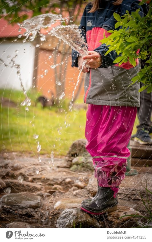 Lightness | A girl squirts water with a water hose Girl Child Colour photo Infancy Human being Exterior shot Joy Positive 3 - 8 years Curiosity Day fun