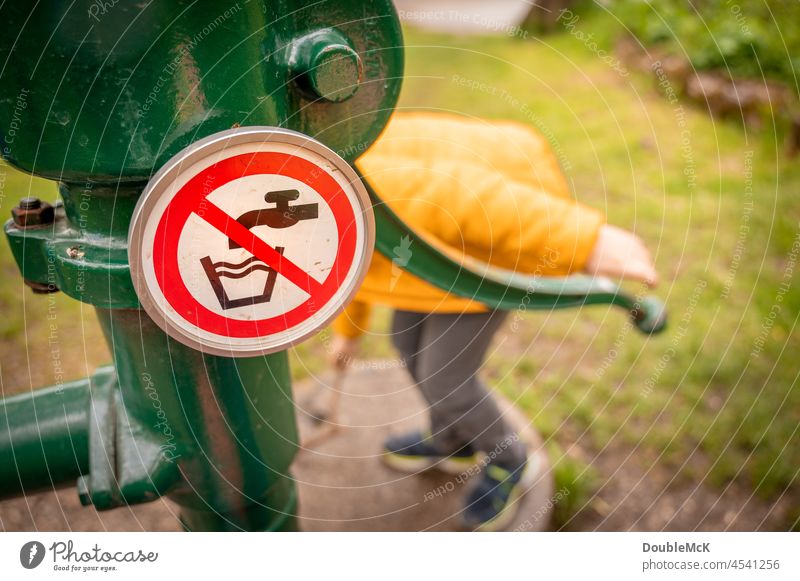 No drinking water - A prohibition sign on water pump Child Colour photo Exterior shot Curiosity Day 1 Multicoloured Water Drinking water Pump Playing