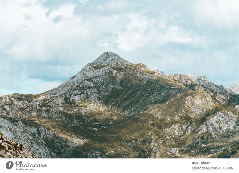 Colorful landscape of the mountains of Asturias during a sunny day, Covadonga lakes, peaceful scenario, snowy mountains, copy space peak meadow scenery lagoon