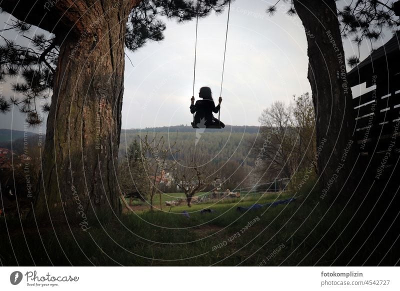 little girl on swing between two tree trunks Swing To swing Girl Child Movement Ease Infancy Dream Floating Tall Dreamily Nature out balance Easy Exterior shot