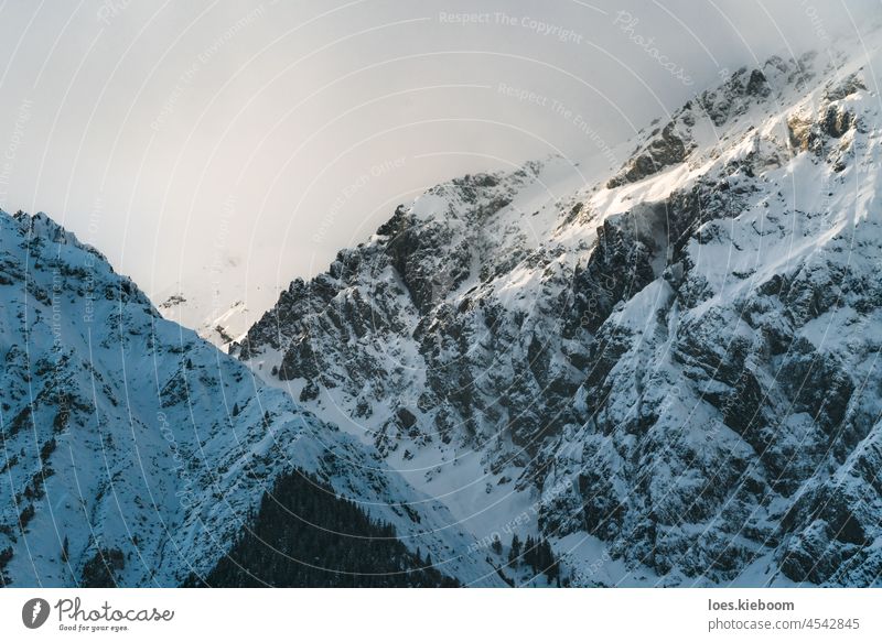 Snowcapped alpine mountains with cloudy peaks at 'Mieminger Kette', Tirol, Austria snow winter fog white rock mieminger kette nature sun landscape sky travel