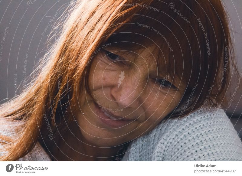 Hopeful - woman with red long hair , head tilted on shoulder, looks with a smile hopeful and curious Woman Long-haired Redheads Face Adults Feminine portrait