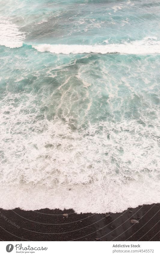 Foamy sea on dark sand wave foam shore water coast nature coastal seaside beach seashore coastline tide black ocean waterfront summer seafront aqua scene