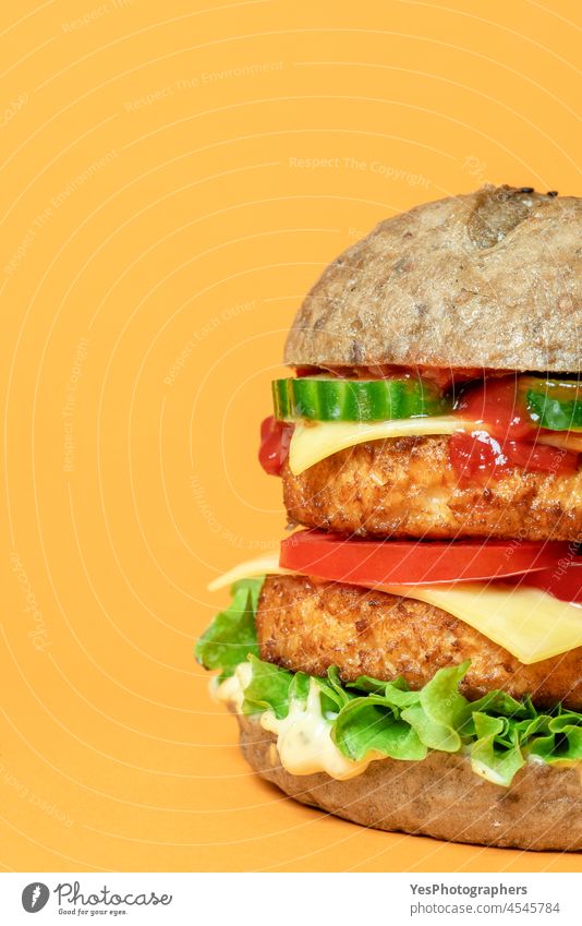 Veggie burger close-up isolated on an orange background. alternative bread bun cheese cheeseburger color consumerism cuisine delicious dinner double eating