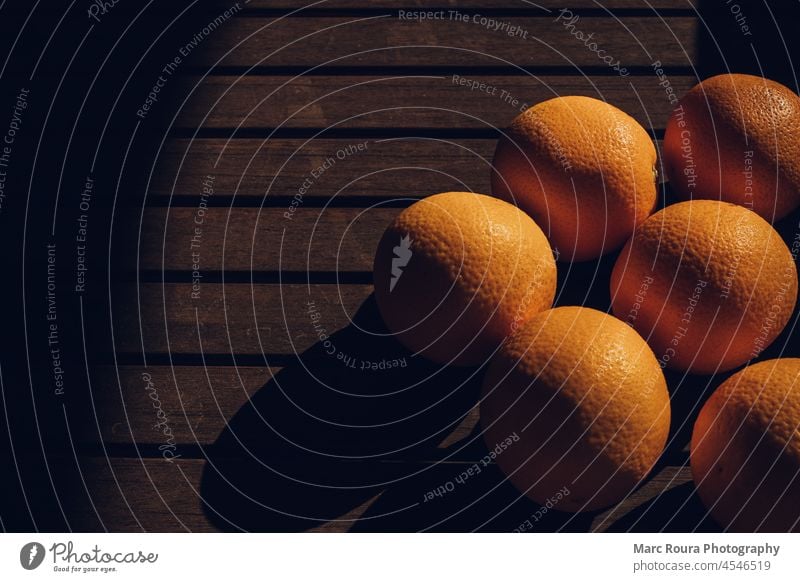 orange fruits on a dark the table abstract background breakfast brown citrus closeup colorful cooking creative diet food for text fresh freshness garden green