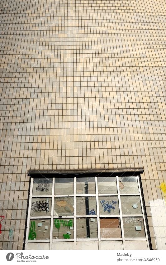 Façade of a high-rise building in beige and natural colours with a curtained window on the ground floor in summer sunshine in the Senckenberganlage in the Westend of Frankfurt am Main in the German state of Hesse