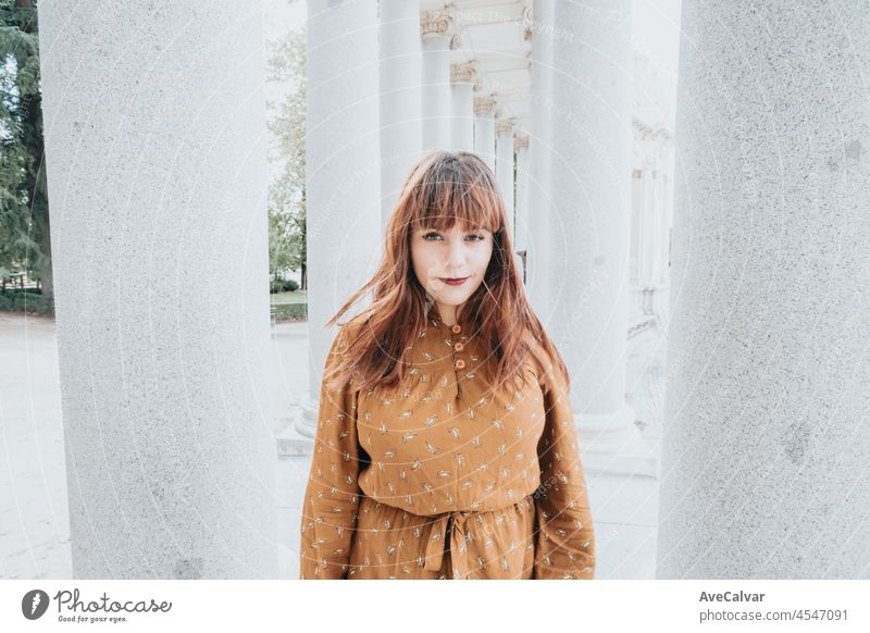 Super smiling close up portrait she her hipster redhead young woman with smart phone. Copy space for text image. Casual dressing in autumnal tones. red lips and modern hairstyle, bright day.