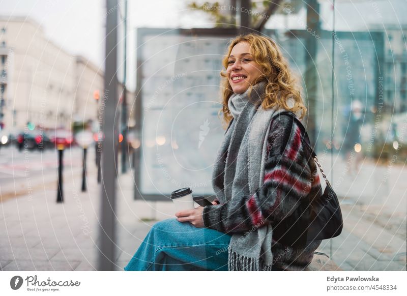 Young woman at bus station one person adult beautiful casual female girl people lifestyle urban city street attractive town portrait young millennials Warsaw