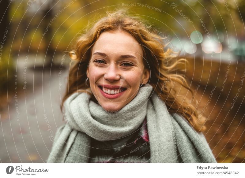 Happy young woman in autumn park one person adult beautiful casual female girl people lifestyle urban city street attractive town portrait millennials Warsaw