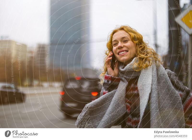 Young woman in the city waiting for a taxi one person adult beautiful casual female girl people lifestyle urban street attractive town portrait young