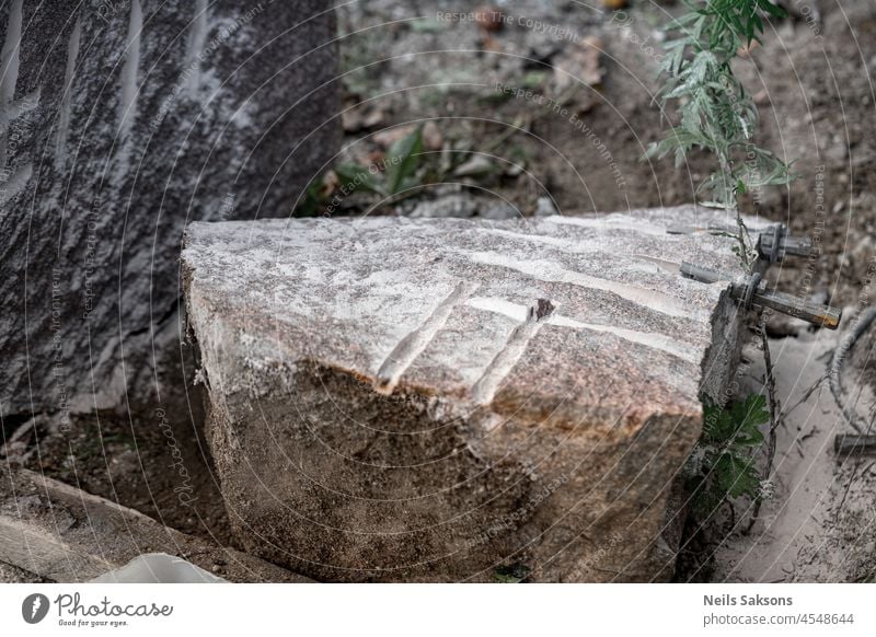 splitted granite boulder with drill holes and metal wedges abstract ancient archeology architecture background brown building city construction culture damaged