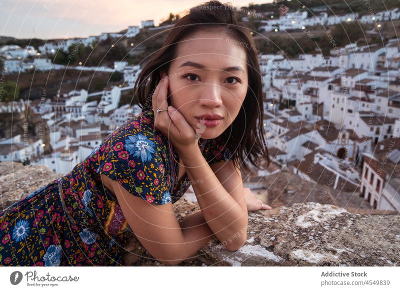 Asian woman resting against ancient town travel building old tourist recreation tourism trip architecture sightseeing aged summer vacation female asian