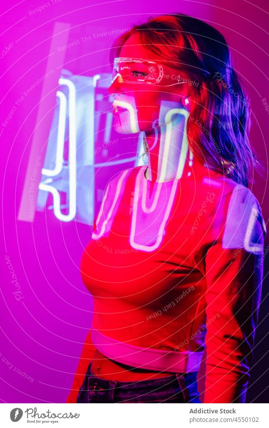 Young Woman In Projector Lights with led futuristic glasses projector bright color colorful confident videogame technology contemporary cool creative dark