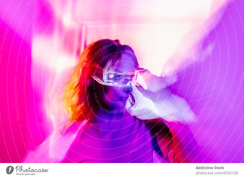 Young Woman With Led Glasses Eyes In Studio videogame creative futuristic virtual reality woman metaverse neon long exposure light colorful illuminate weird