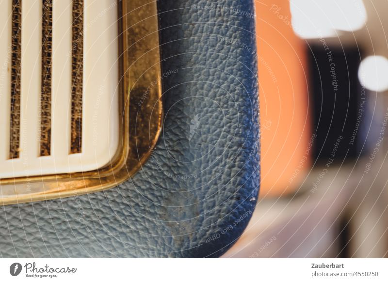 Detail of a portable radio with brass, plastic and grey imitation leather, blur Synthetic leather Brass Plastic Gray Housing 50s '60s technique