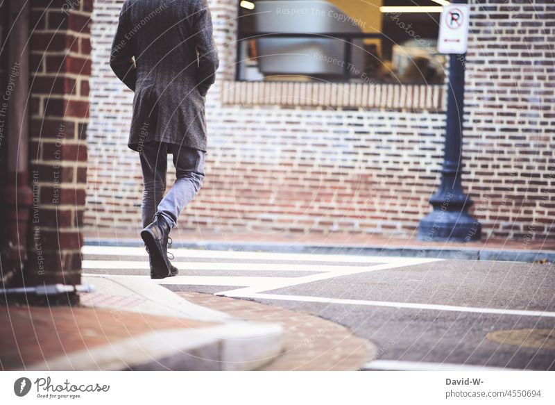 Man crossing a zebra crossing Zebra crossing Traverse Going Town Anonymous City life Street Pedestrian