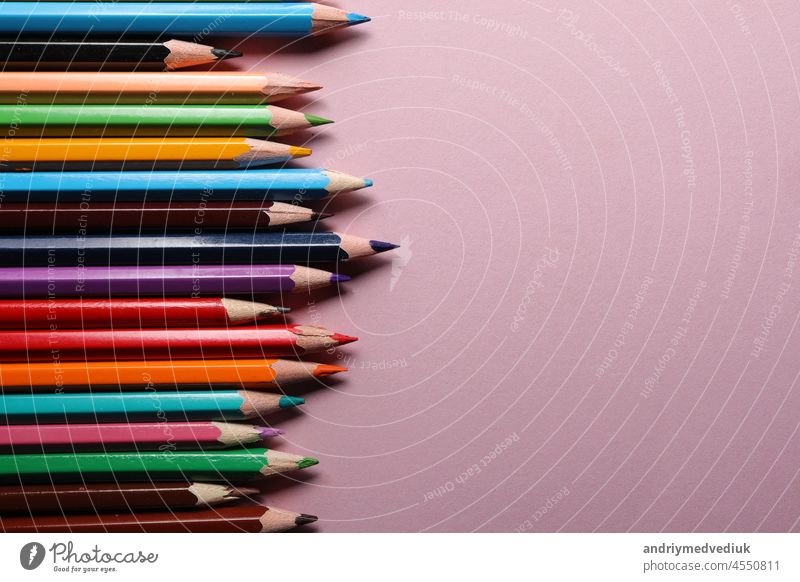 Color pencils set, row wooden color pencils isolated on pink background. colored pencils for drawing. copy space. up close sharp rainbow group green education