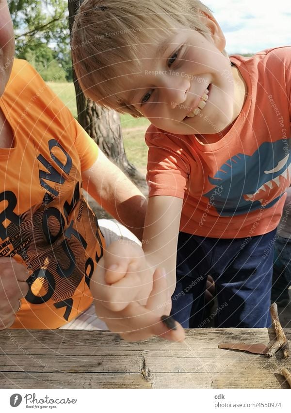 Childhood | Cheeky bug Boy (child) Smiling Grinning muck about Funny wittily Hand Beetle Indicate joke Infancy Happiness Summer Ease Face Contentment Family