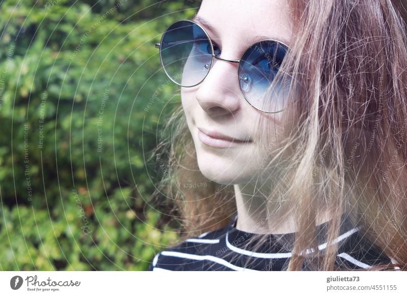 My world is sky blue | Portrait of a 12 year old girl with long hair and blue sunglasses portrait Girl Looking into the camera Half-profile Front view