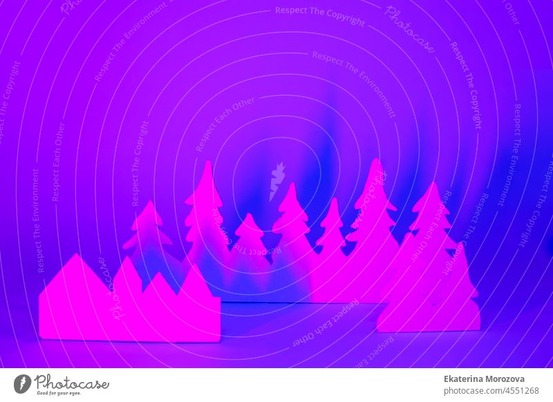 Futuristic modern abstract happy New Year 2022, Merry Chrstmas concept. Pine tree from paper on neon bright violet blue background, copy space, banner for your site, invitation, flyer