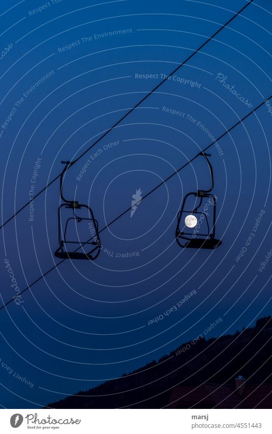 surreal | full moon, the last passenger on the chairlift. Just left sitting. chair lift Full  moon Winter Lift shutdown Evening Twilight blue hour Ski operation