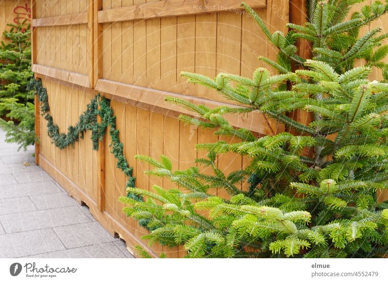 closed christmas stall made of wood decorated with christmas trees and fir green / anticipation / corona regulation sales booth Christmas booth Anticipation