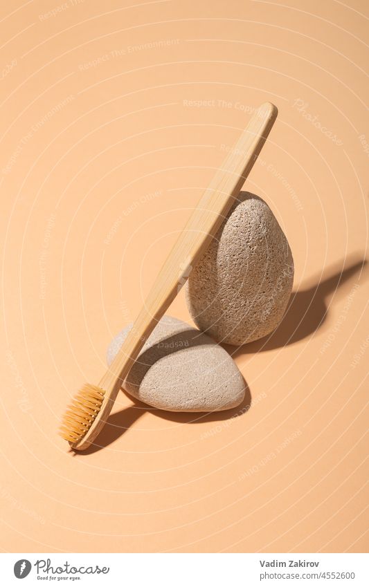 Wooden toothbrushes on brown background and stones, zero waste wooden beige toiletries routine morning lifestyle hygiene health equipment eco dental healthy