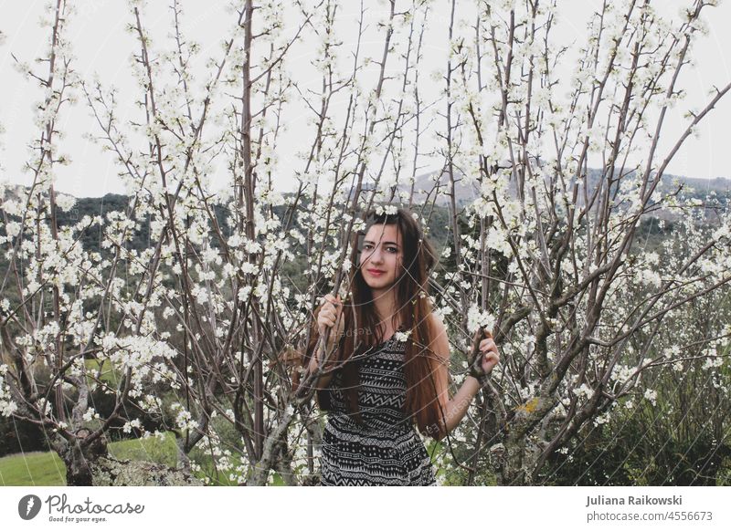 young woman between cherry blossoms long hair Lifestyle Elegant Hip & trendy Joy cheerful Laughter Happiness Style Emotions fashion photography model Fashion