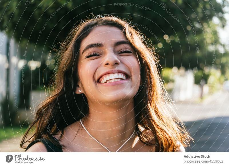 Happy lady enjoying summer day on street woman portrait content eyes closed smile cheerful expressive delight positive happy pleasant female hispanic ethnic