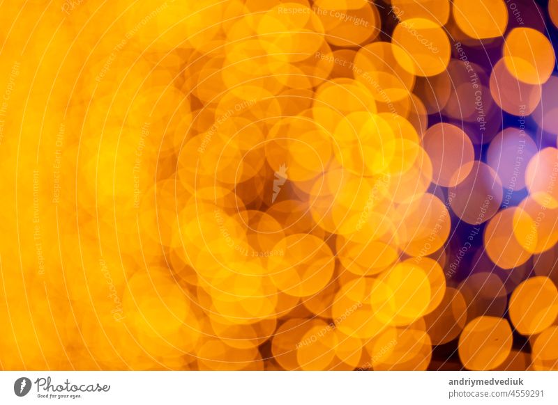 Abstract circular bokeh background of Christmaslight. bokeh from garlands. background for screensaver. Defocused lights. Blurred bokeh with yellow color lights.