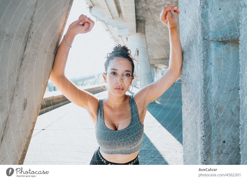 Portrait of a smiling young african arab woman smiling after jogging at outdoors. Urban exercise outdoors. athlete athletic runner sportswear confident