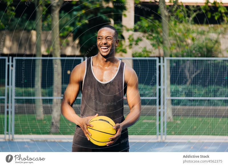 Happy black basketball player holding ball man sport training sportsman game stadium activewear sports ground motivation confident ethnic concentrate smile